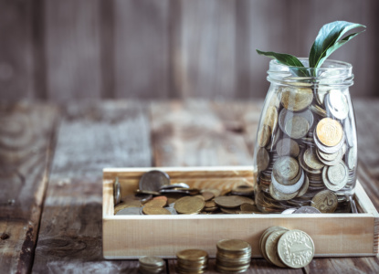 bank with coins and green sprout