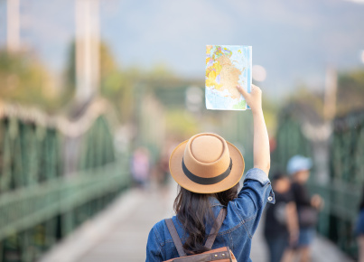 Female tourists on hand have a happy travel map.