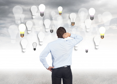 man-touching-her-head-looking-bulbs