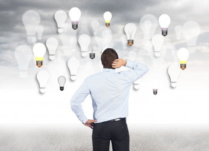 man-touching-her-head-looking-bulbs